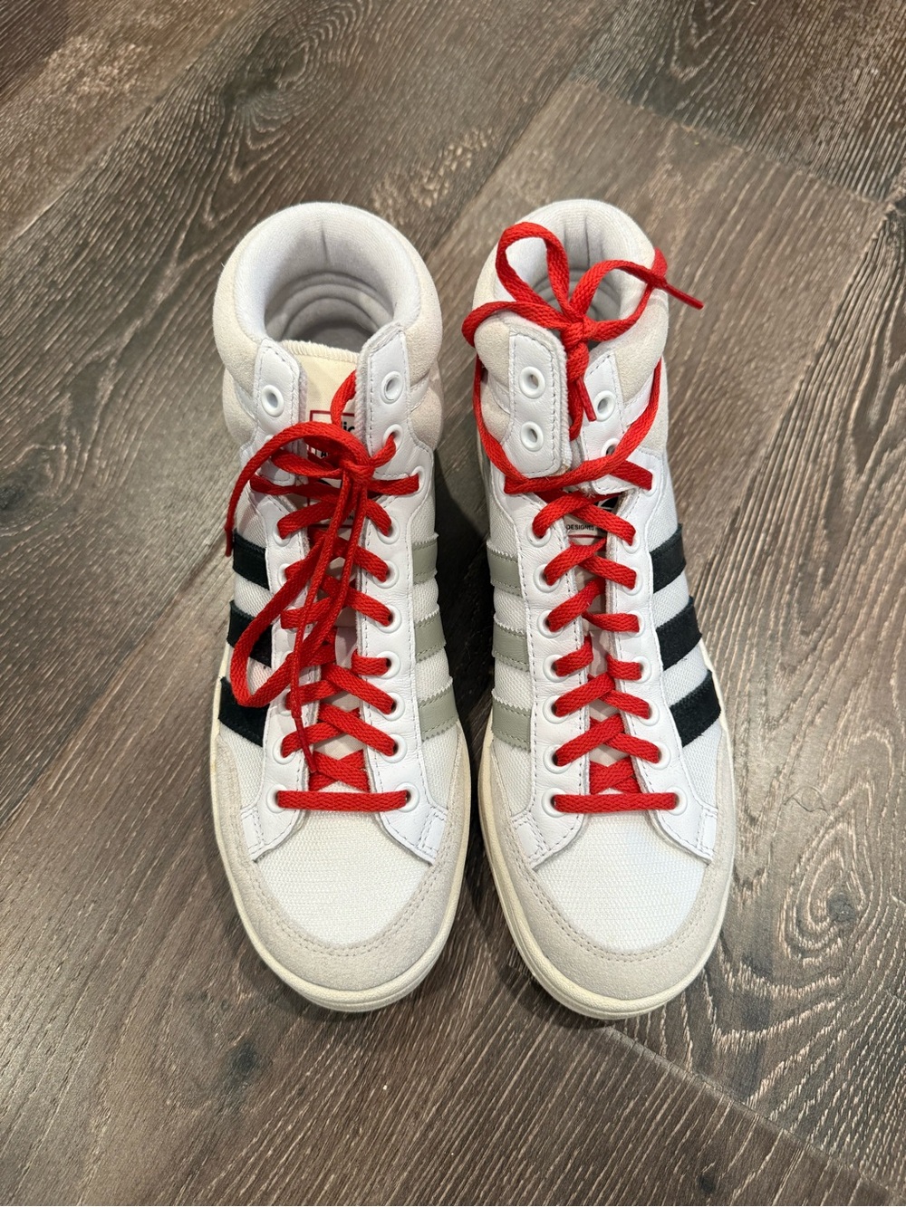 adidas White High-Top Sneakers with Black Stripes and Red Laces